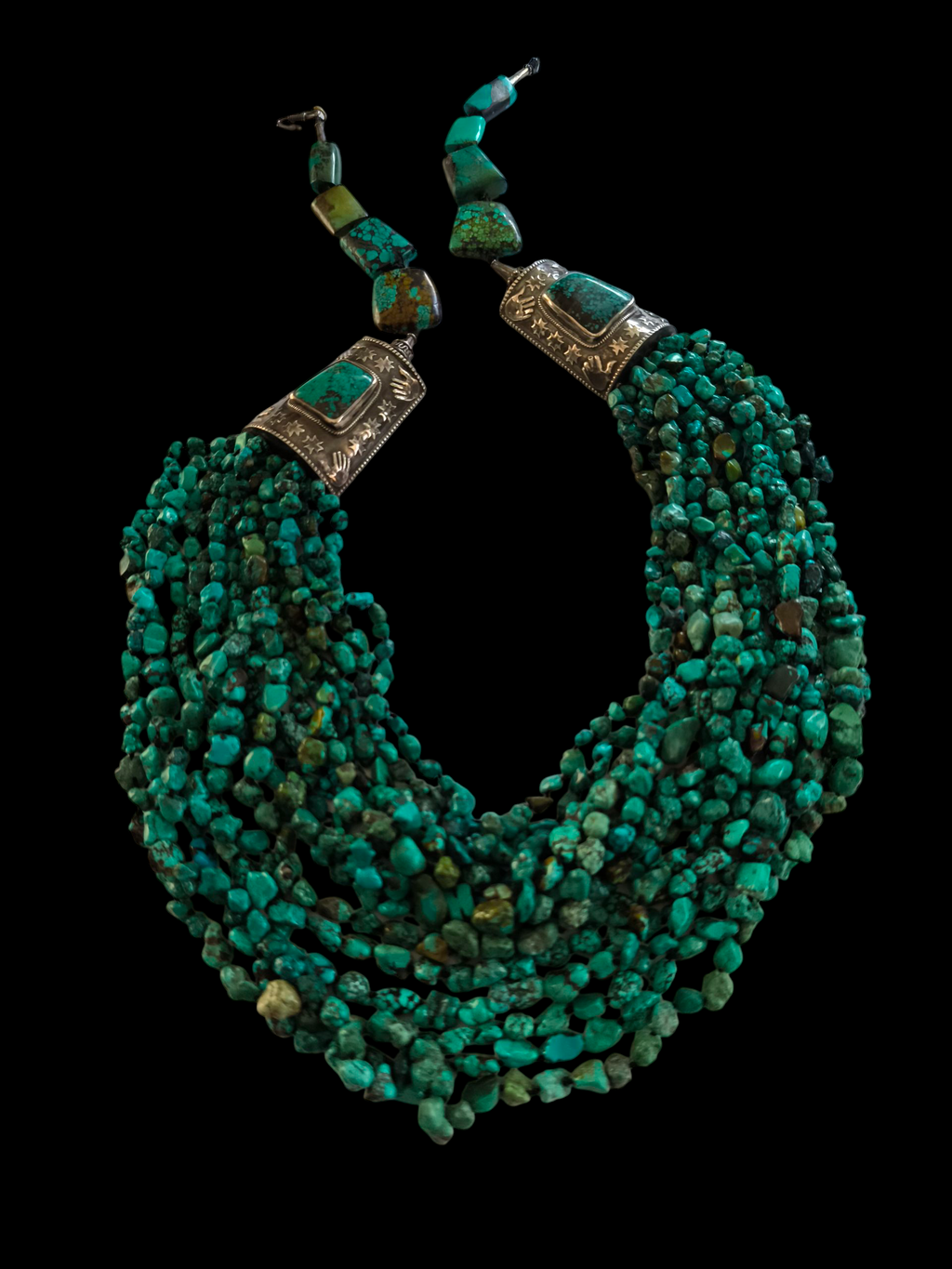 Collar tibetano con 15 vueltas de turquesas, 2 piezas artesanales hechas a mano con plata de ley y turquesas y 8 grandes turquesas tibetanas en la parte posterior. La turquesa es considerada por los tibetanos como un amuleto protector y sanador, que aleja el mal de ojo y las energías perjudiciales. Longitud máxima 110 cm / mínima 75 cm Peso 620 g Tibetan necklace with turquoise and silver. Lula Máiz