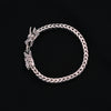 Pulsera artesanal hecha a mano con plata de ley y dos cabezas de dragones. El dragón es símbolo de fuerza, coraje y sabiduría en Oriente y portador de buena suerte.  Se abre presionando en la cabeza de uno de ellos. Longitud 19 cm Peso 53 g. Flexible bracelet. Dragon bracelet. Lula Máiz