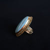 Anillo artesanal hecho a mano con plata de ley, baño de oro mateado y gran cabujón de larimar. Tamaño 19 Medidas 4´5  cm x 3 cm Peso 22 g. Handcrafted silver ring. Gold plated silver ring with larimar. Lula Máiz. XL silver rings