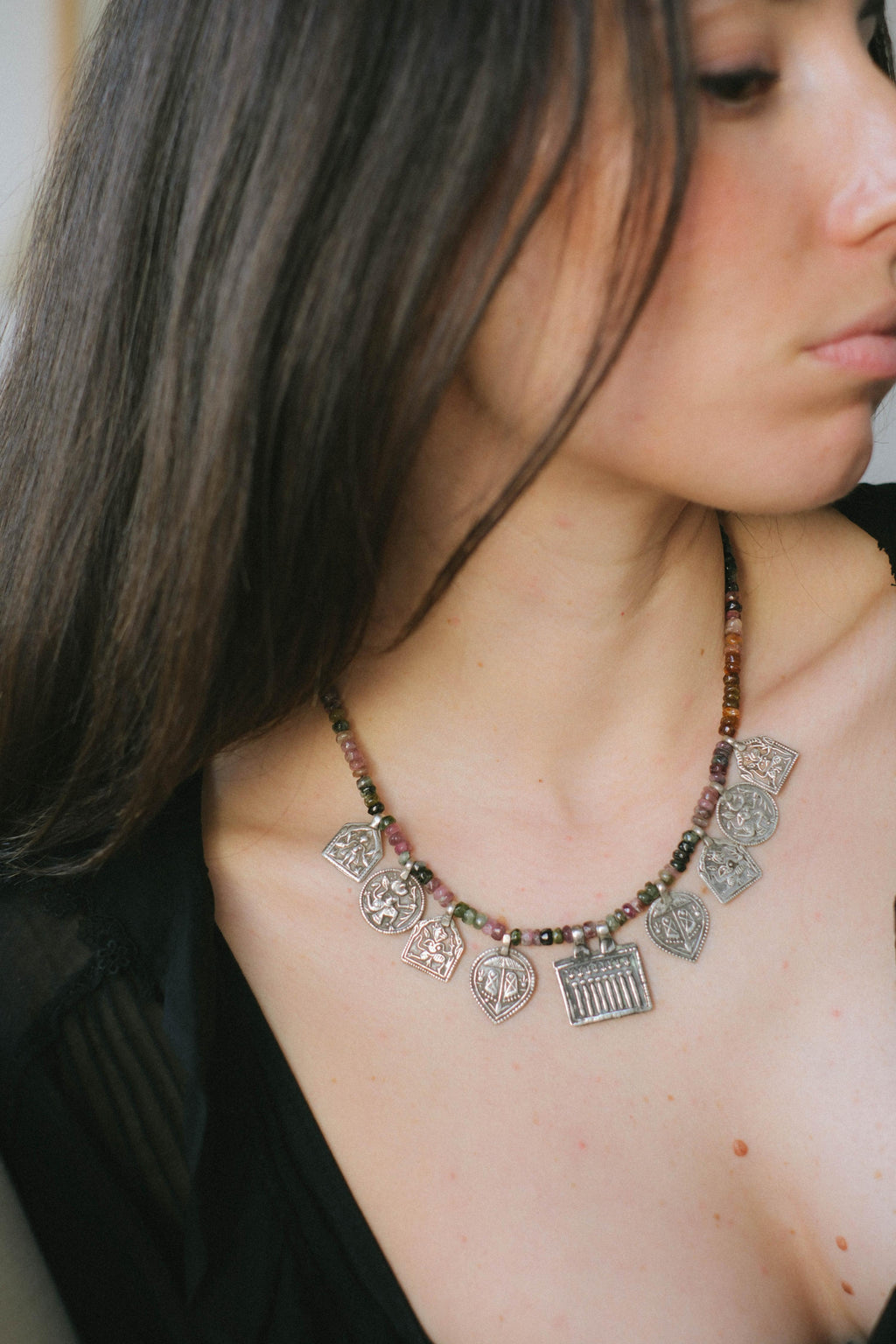 Collar con turmalinas multicolores y amuletos antiguos de India hechos con plata. Representan diversas deidades hindúes y tribales, como las Siete Hermanas, Hanuman el dios mono, las huellas del dios Vishnu, también conocido con el nombre de Narayana. El cierre es contemporáneo de plata de ley. Longitud 46 cm Peso 40 g. Pieza única, diseño de Lula Máiz. One of a kind by Lula Máiz