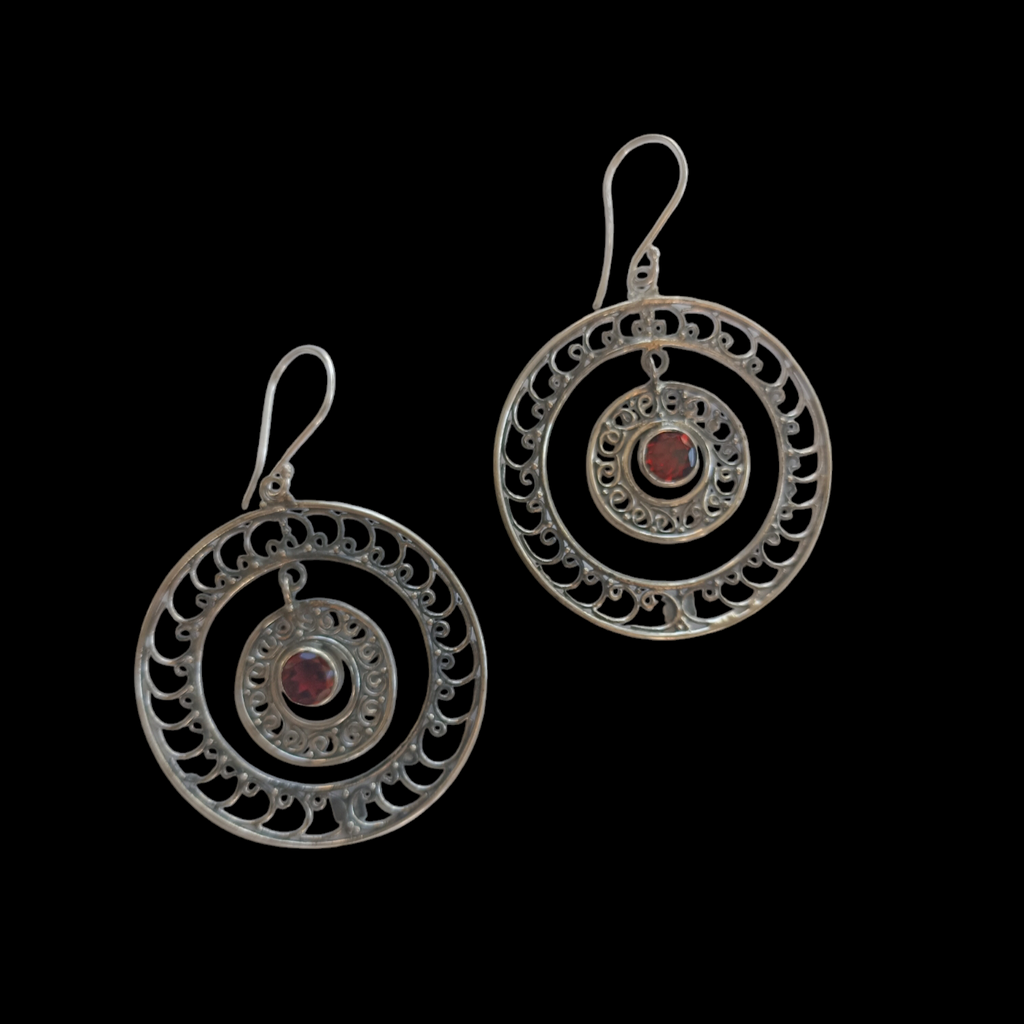 Pendientes artesanales hechos a mano con plata de ley y granates facetados. Disponibles en plata y plata con baño de oro mateado. Diámetro 37 mm Peso 7 g. Handcrafted silver earrings with cut garnets. Lula Máiz